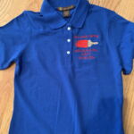 Blue polo shirt with red embroidered logo