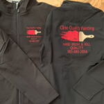 Two black jackets with Cline Quality Painting logos