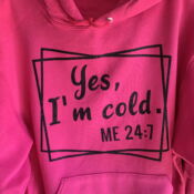 A close up of the front of a pink hoodie