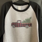 Plaid pickup truck carrying Christmas tree shirt