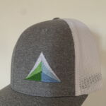 Gray trucker hat with green blue mountain logo